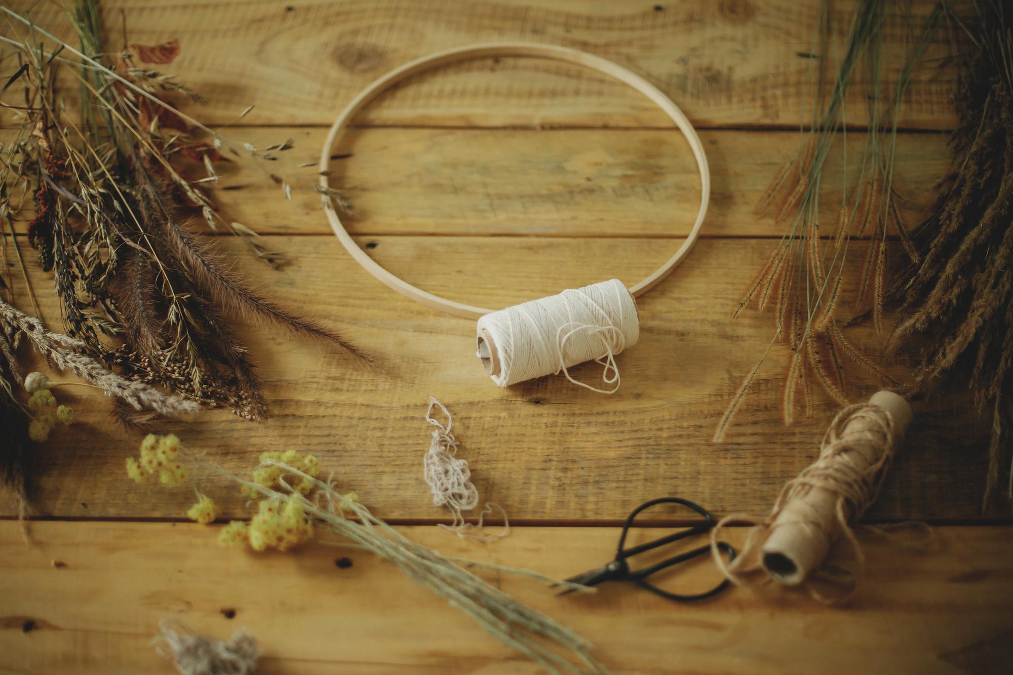 Workshop workspace with threads and hoop on wooden table